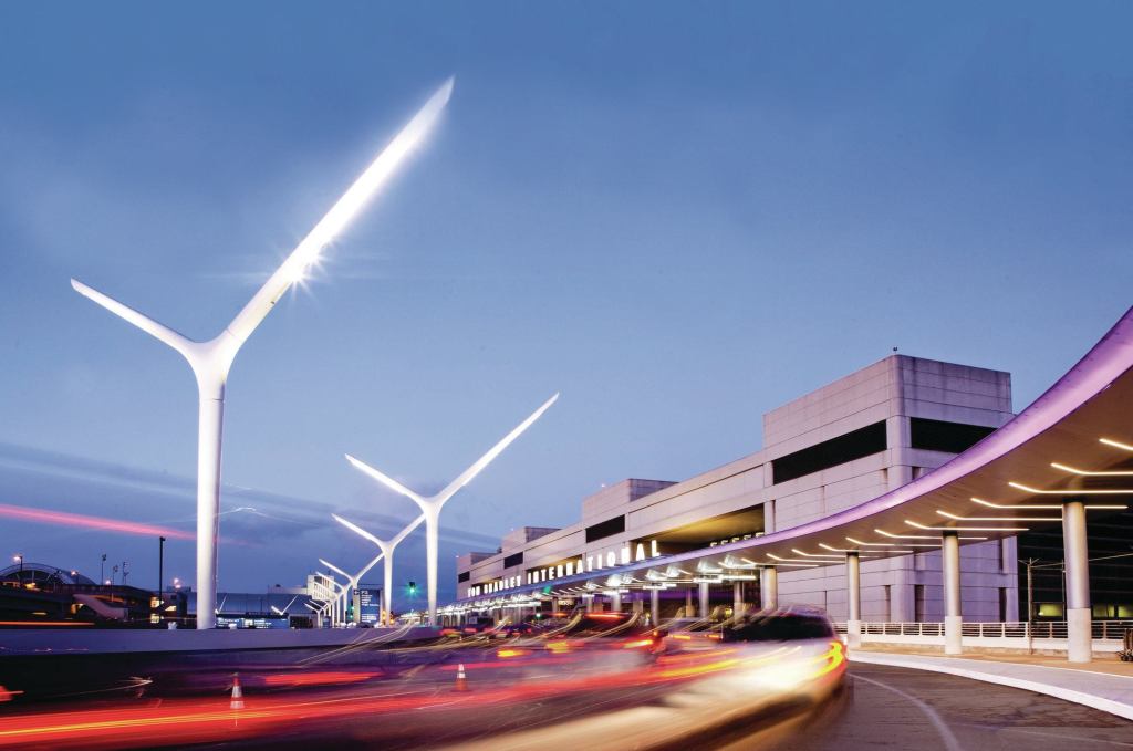 Improvements to the curbside environment at LAX’s Tom Bradley International Terminal (TBIT) include sculptural light poles, under-canopy lighting, and a color-changing light ribbon along the canopy edge.