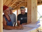 Lenny Lone Hill (left), with Oglala Lakota College, and Rob Pyatt (right), with the University of Colorado at Boulder, working inside a prototype straw-bale house that's being built by the Native American Sustainable Housing Initiative.