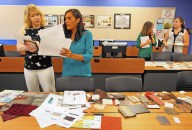 Designing for speical needs: Autism class students , Corene Beehner,left, Ledy Martinez-Loor, right, (foreground) and Kristy Rapp, left, Natalie Vince,(background) gather materials Tuesday, October 21, 2014 for their design presentations. Seminole State College is offering a unique course -- interior design focused on the needs of people with autism. The class is creating plans to redesign the kitchen of a Seminole State board member whose two children have autism.(Red Huber/ Staff Photographer)