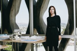 Jennifer Marmon stands beside a section model for PAR’s Helsinki Central Library proposal. The firm collaborated with Arup on a highly technical, transparent façade with thermal properties.