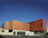 The addition cantilevers over the entrance to a 450-car parking garage shared by the Wallis and City Hall (beyond).