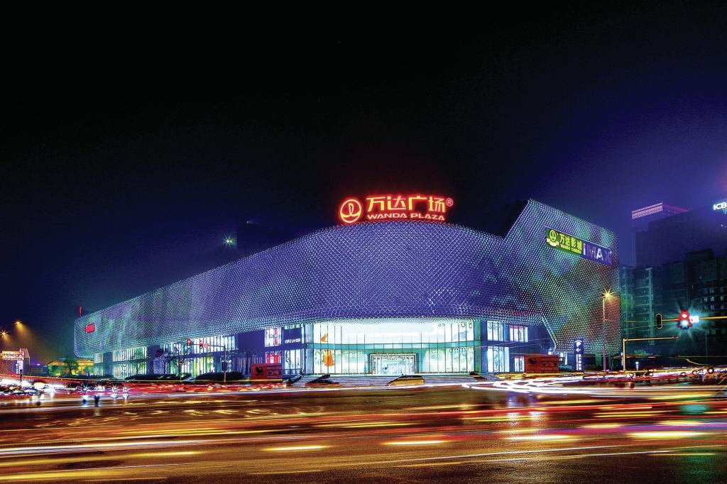 Opened in September 2013, this 860,000-square-foot luxury shopping plaza in Wuhan, China, features a façade illuminated with 3.1 million LEDs housed in 42,333 stainless steel spheres. The façade has no right angles, but rather wraps its way around the five-story building. Silver by day and pulsing with color at night, the fixtures cluster above entrances to steer wayfinding.