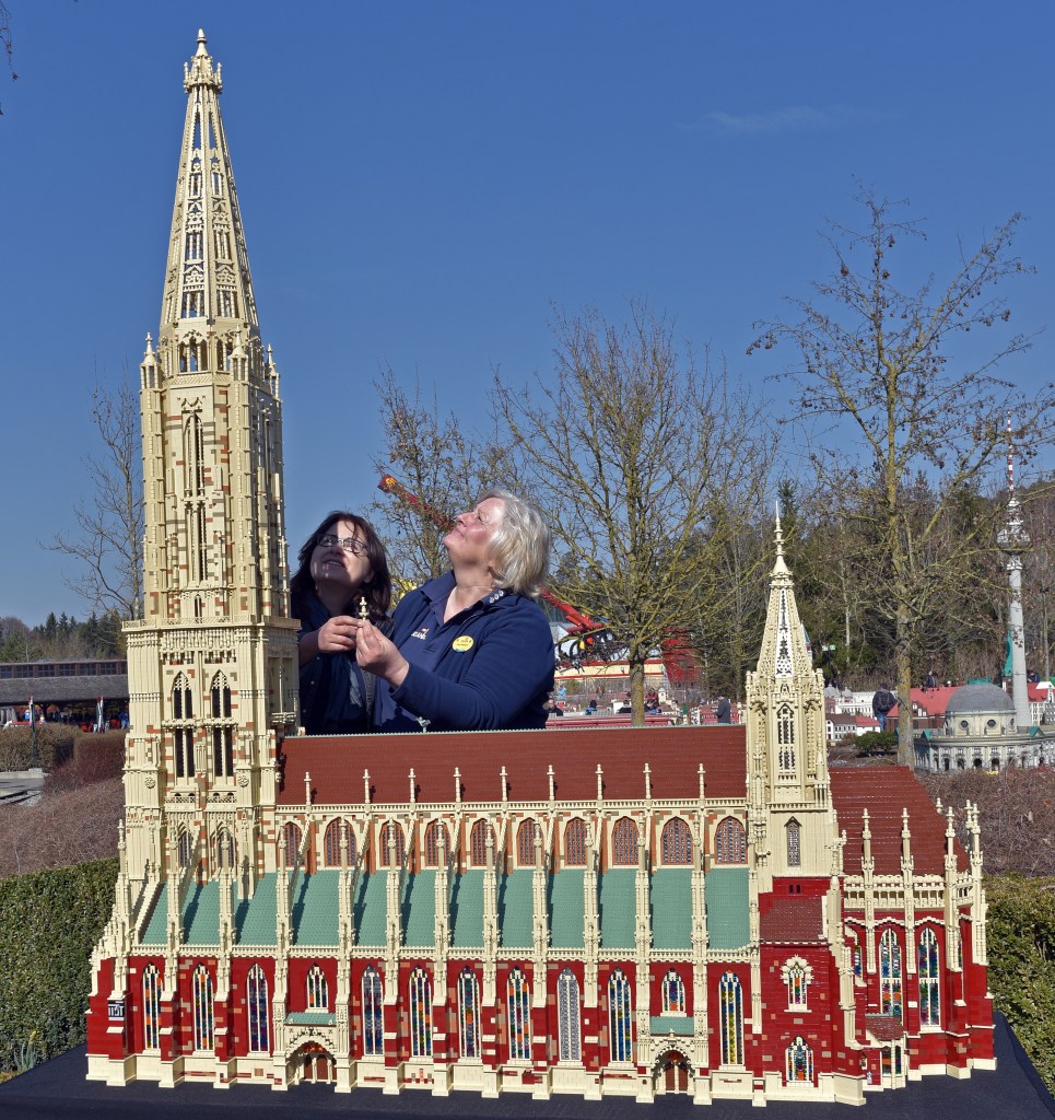 Model designers Vera Feldmann and Anastasia Trautwein stand by a replica of Ulm cathedral at Legoland Germany. The scale model of the world's largest church tower took 4 months and over 112,000 Lego bricks to build.&nbsp;