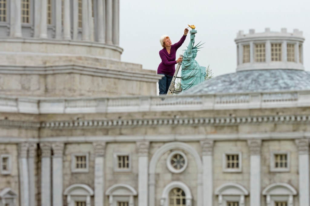 Model maker Helga Mueller restores a miniature Statue of Liberty at the landscape park Miniwelt (Miniworld) in Lichtenstein, eastern Germany. Miniwelt presents about 100 original and true-to detail buildings and technical facilities at a 1:25 scale.