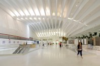 Commuters walk through the mezzanine of the newly opened Platform B at the World Trade Center transportation hub in New York. When the $3.9 billion transportation hub opens later this year, commuters and visitors will get to decide for themselves whether Spanish architect Santiago Calatrava, FAIA's bird-in-flight design has been translated into a grand public space that justifies years of delays and cost overruns.