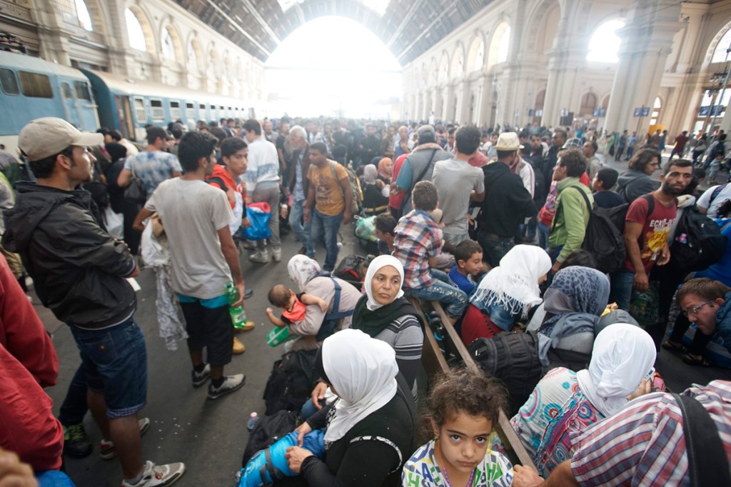 Migrants  wait inside the Keleti Railway Station in Budapest, Hungary. Migrants are now allowed to enter the station but direct trains from Budapest to Western Europe are currently out of operation until further notice.