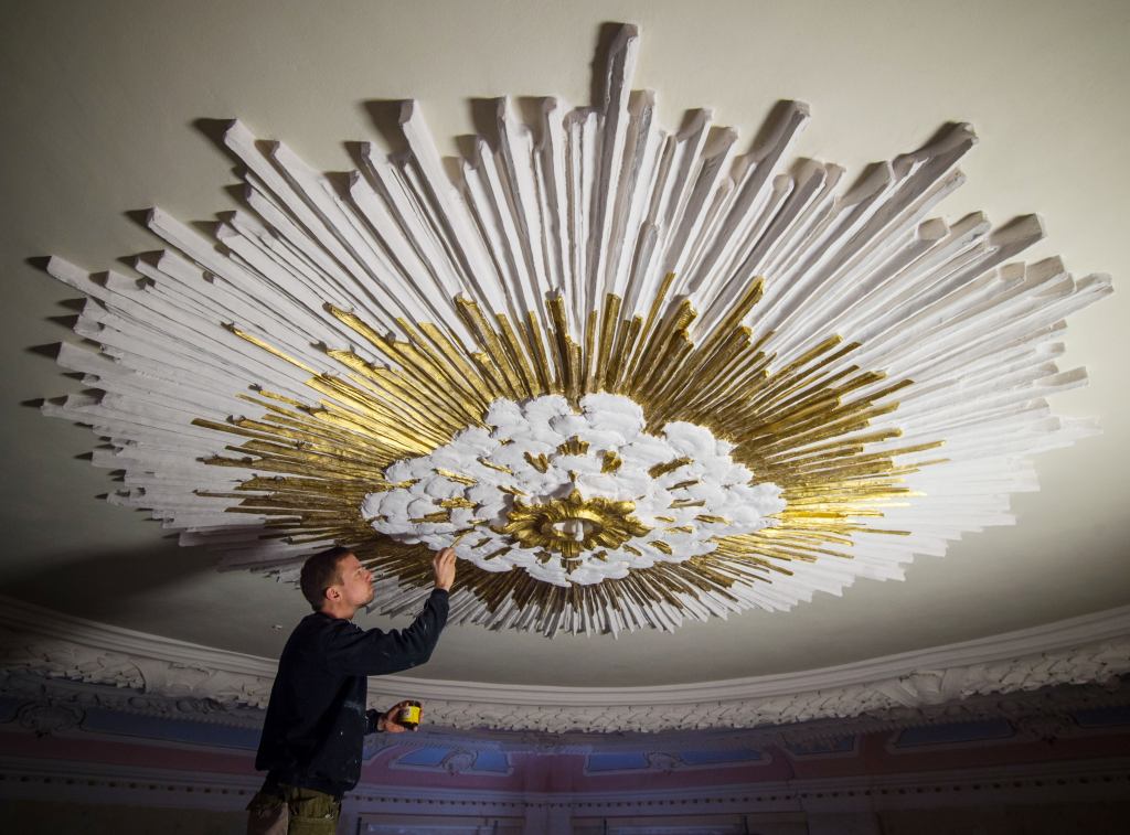 Restorer Andre Baer paints the stucco work on the ceiling of the palace chapel in Altlandsberg, Germany. The historic building, which has been under the ownership of the city since 2008, is one of the few remaining examples of the Baroque style in Brandenburg. The chapel was built at the end of the 17th century and in 1786 it was rebuilt following a fire. The extensive renovations began in May 2013, and the building is intended to become a multifunctional event center.