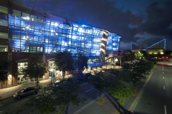 Exterior 11,000 square foot wall backlit at night. 