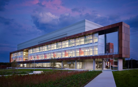 A view of the northern, entrance façade at dusk shows the transparency and clarity of the design; a new face for government science. 