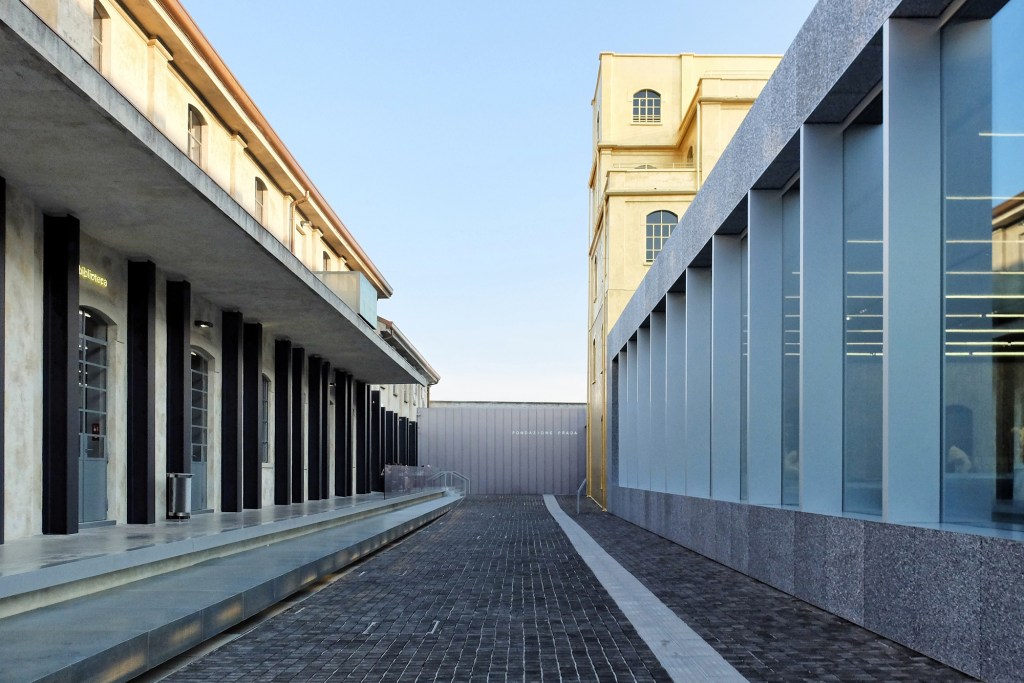 A view of the forecourt and understated museum entrance at OMA's Fondazione Prada, in Milan.