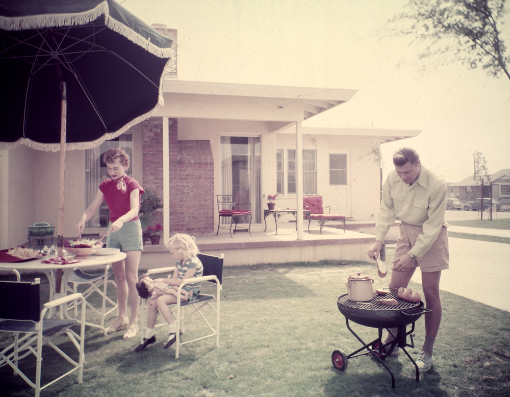 A family enjoying a barbecue in their backyard.