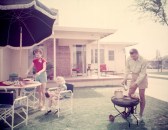 A family enjoying a barbecue in their backyard.