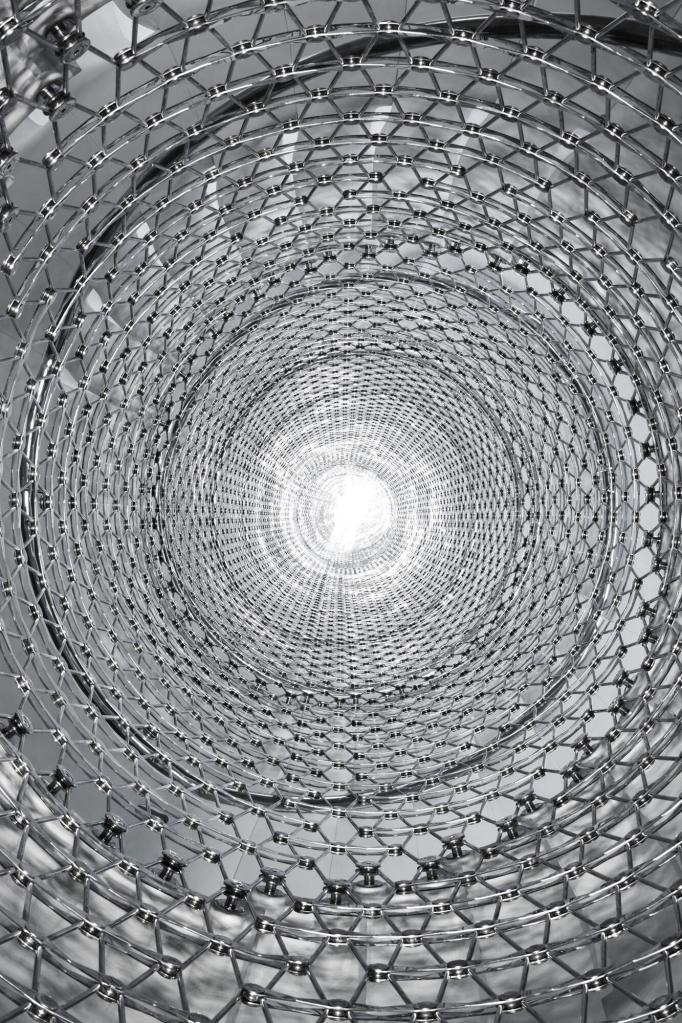 The Miles Stair stainless-steel mesh newel rises five stories.