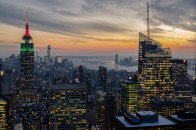 New York City's illuminated skyline at dusk.