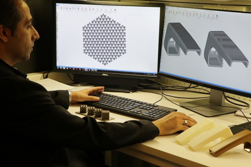 Dr. Rashid Abu Al-Rub, an associate professor of mechanical and materials engineering at the Masdar Institute, demonstrates the use of nanoengineered materials to make airplane armrests lighter.