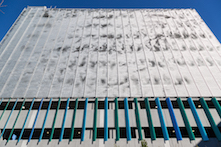 The dynamic façade system consists of more than 48,000 aluminum flapper panels that move in response to wind currents.