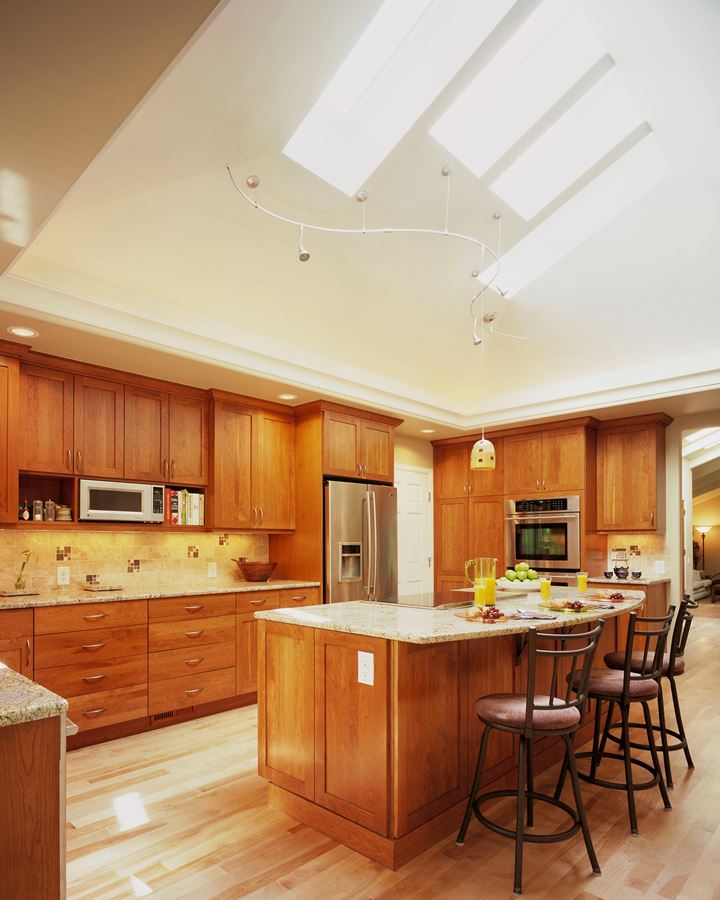 This kitchen designed by Doug Walter uses five LED lighting circuits, all on dimmers: undercabinet lighting, recessed cans, the uplit cove, track head task lighting, and decorative pendants.