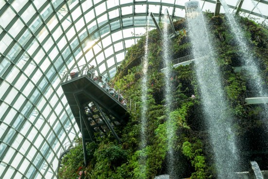A waterfall inside one of two climate-controlled conservatories at Singapore's Gardens by the Bay park provides mist to maintain a cool, moist environment.