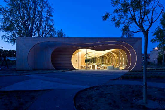 Glass partition walls divide classroom spaces while maintaining transparency through the building.