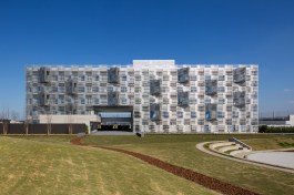 A breezeway, marking the entrance, is cut through the first and second floors of the five-story building.