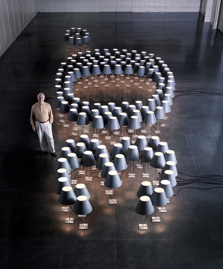 Designer Paolo Rizzatto with 150 Constanza lamps.