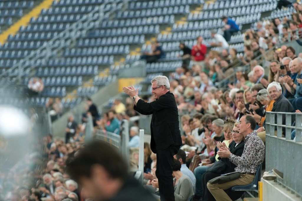 Daniel Libeskind applauds a violinist at Commerzbank Arena in Frankfurt, Germany