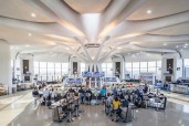 A view of the terminal at midday when the color temperature of the petal fixtures transitions to 4000K to balance the abundance of natural light.