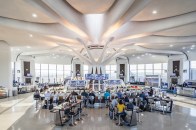 A view of the terminal at midday when the color temperature of the petal fixtures transitions to 4000K to balance the abundance of natural light.