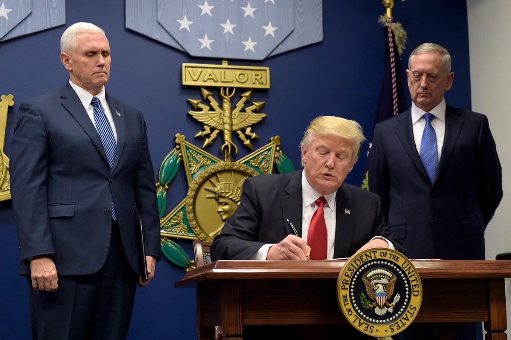 President Donald Trump signs the executive order at the Pentagon on Jan. 27.