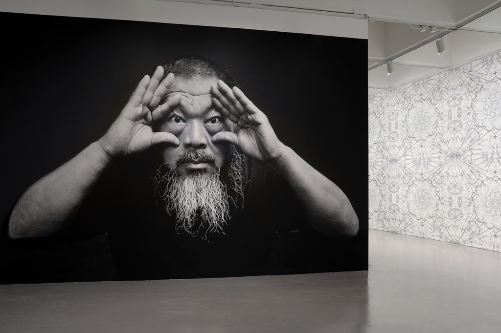 Portrait of the artist at the entrance of "Ai Weiwei: Trace at Hirshhorn"