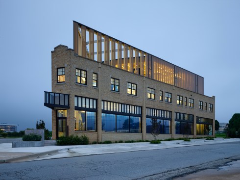 South elevation illustrating the 3rd floor glass addition and the protected outdoor deck. Triangular shaped down spouts show consistent detailing
