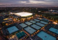 Night time aerial scene over the Wimbledon Grounds in 2015. The roof is closed and lit up as play goes on late into the evening.