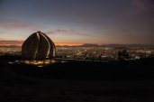 The House of Worship at night overlooking the city of Santiago.