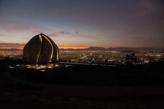 The House of Worship at night overlooking the city of Santiago.