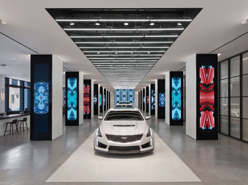 The latest models from Cadillac are displayed on a runway where a combination of light source technologies highlights the automobiles’ forms and features.