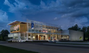 The contemporary design of the museum recalls familiar elements such as the large front porch which can be found on so many Southern homes and corrugated metal siding reminiscent of rural farm buildings .