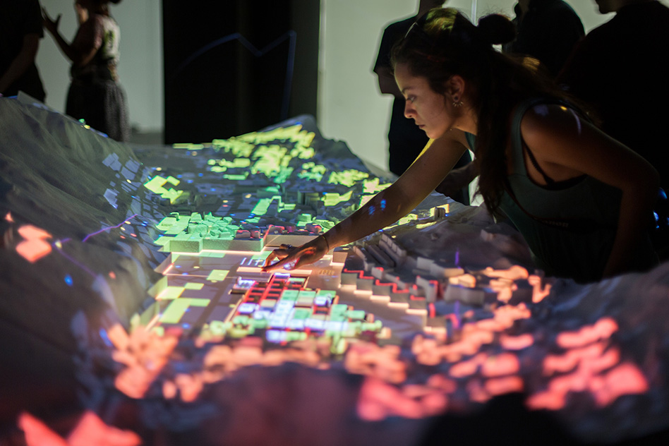 CityScope Andorra is a 3-D augmented-reality platform that visualizes complex urban data on a small-scale model of the country. Users can interactively test scenarios on the model, such as how many parks to include in a city, adjust heights of buildings, calculate the optimal mix of residential and commercial real estate, and whether to allow private vehicles or only car-share services. The impacts of these changes on traffic, walkable access to amenities, and other metrics are then updated in real time.