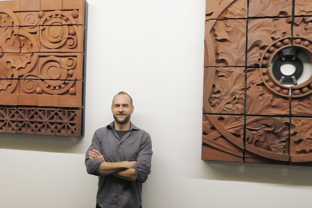 Keith Van de Riet with the students' terra-cotta models.