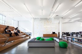 L-bracket lounge with bleacher, stacks and constellation graphic. The field of crosses maps the star constellation Leo - a coded reference to NYPL's ubiquitous lion mascot.