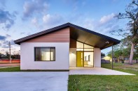 Each house is clad in stucco over concrete masonry unit walls, with an Azek deck-board rainscreen.