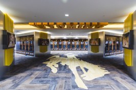 The player locker room inside the Rochelle Athletic Center is designed for the current player, while also recognizing the tradition of the program