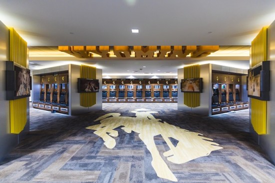 The player locker room inside the Rochelle Athletic Center is designed for the current player, while also recognizing the tradition of the program
