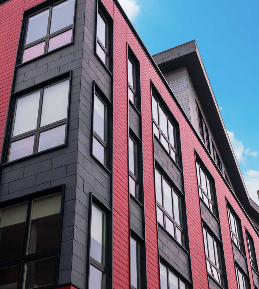 The 35 South Huntington multifamily structure includes custom 9-0 x 9-0 windows from Harvey Commercial Solutions. The impressive vinyl pictures windows were factory-mulled over awning windows. Black painted exteriors complement the overall design of the structure. Photo courtesy of Harvey Commercial Solutions.