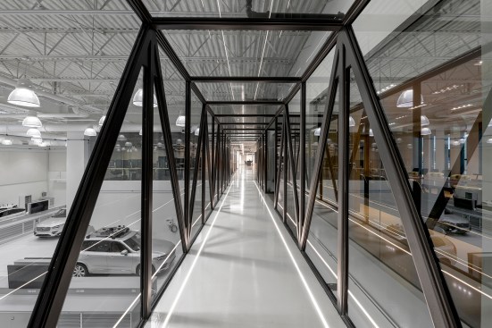A blackened steel bridge connects the two wings of the Uber Advanced Technologies Group offices by Assembly Design Studio.