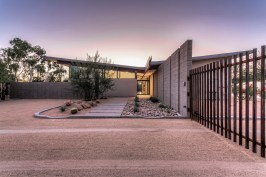 Front entry of home.  The low point of the butterfly roof is centered over the front entry door.  An 
exposed beam connects the roof and creates an organizing element inside and outside the home.  This 
exposed beam defines the interior circulation path of home.