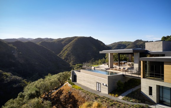 Situated on a promontory jutting into the canyon below, the hillside retreat boasts multiple vistas of the surrounding canyon and the Pacific Ocean beyond.