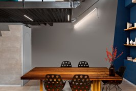 Dining table in the kitchen below iron staircase