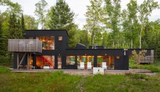 The northwest façade has a deck that faces the lake and is outfitted with Salmela-designed chairs from Loll.
