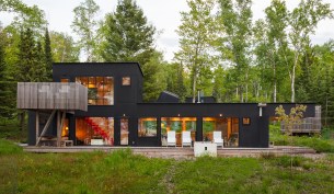 The northwest façade has a deck that faces the lake and is outfitted with Salmela-designed chairs from Loll.