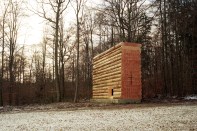 View from east, showing Douglas fir log walls on concrete plinth